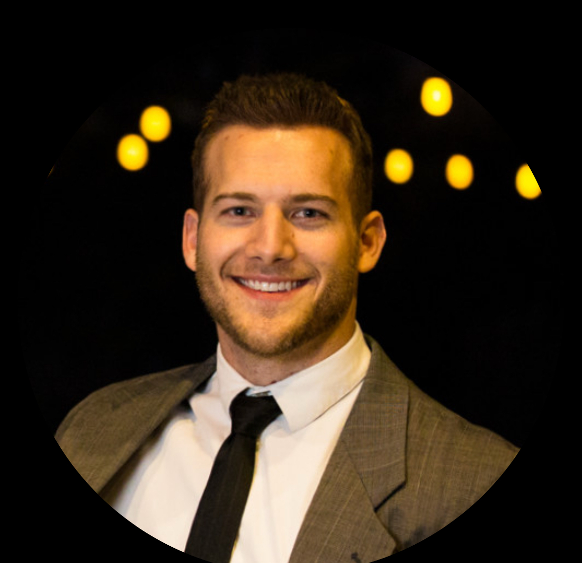 Cameron Bennion, smiling in suit and tie